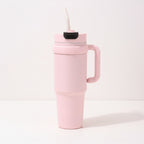 Travel tumbler featuring an integrated side handle and a convenient built-in straw.