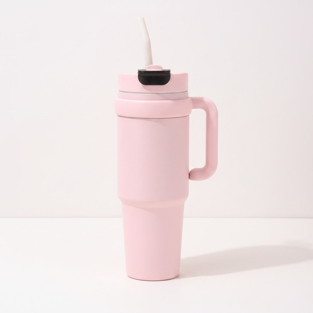 Travel tumbler featuring an integrated side handle and a convenient built-in straw.